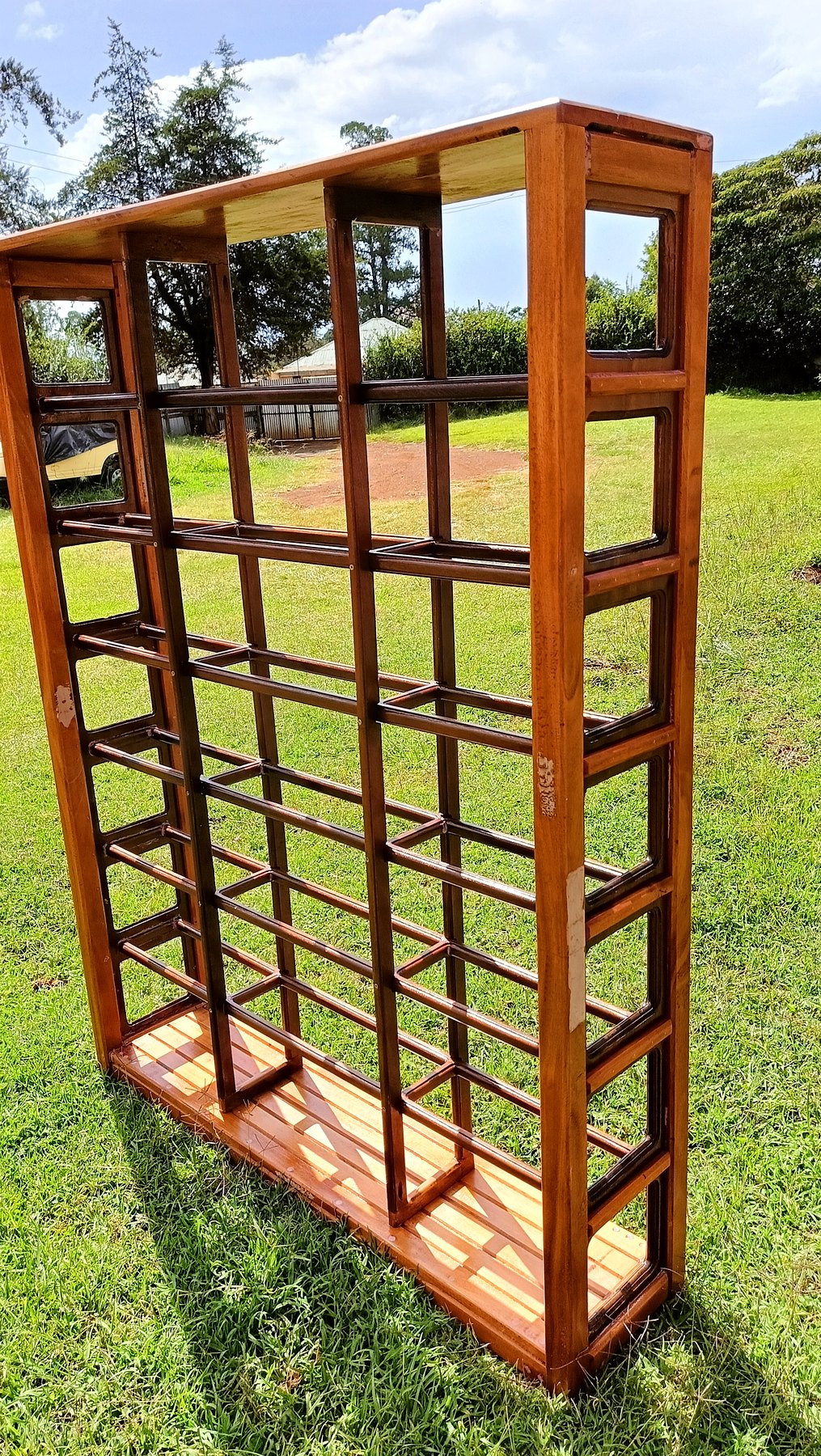 Tall multi-tier wooden display rack outdoors